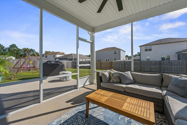 sunroom featuring ceiling fan