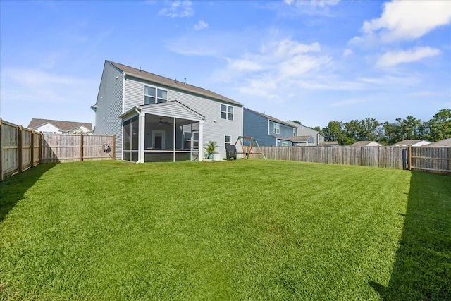 back of house featuring a yard and a sunroom