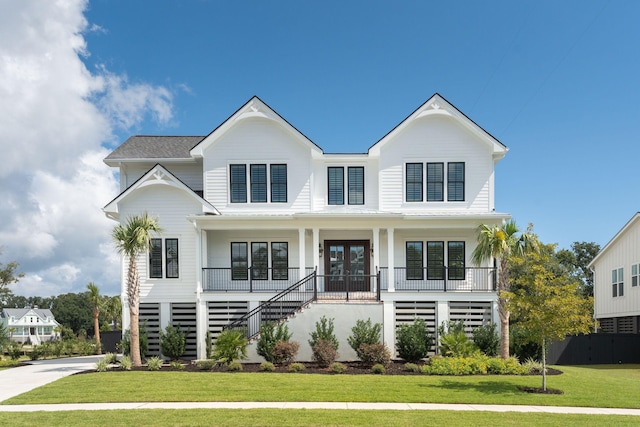 view of front of house with stairs, french doors, a front lawn, and a porch