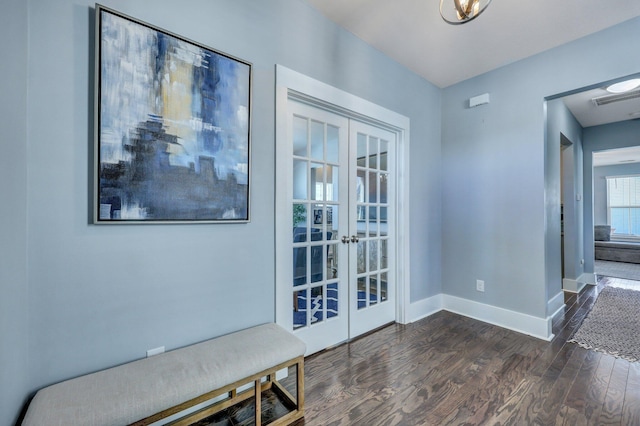 interior space with dark wood finished floors, visible vents, french doors, and baseboards