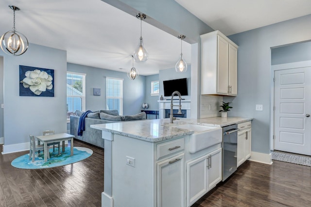 kitchen featuring dark wood-style floors, white cabinetry, a sink, dishwasher, and a wealth of natural light