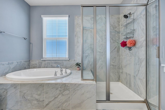 bathroom featuring a bath and a shower stall