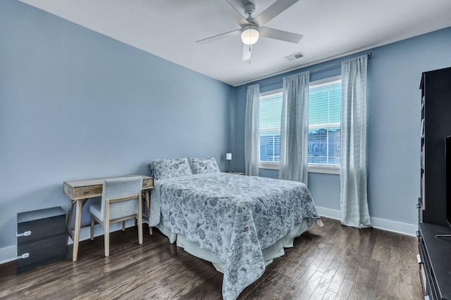 bedroom featuring dark wood finished floors, baseboards, visible vents, and a ceiling fan