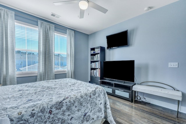 bedroom with visible vents, a ceiling fan, and wood finished floors