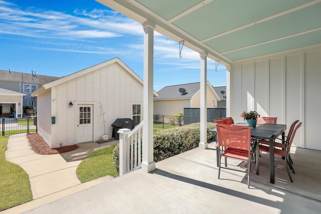 view of patio / terrace with an outbuilding, a grill, outdoor dining area, and fence