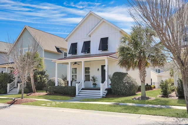 view of front of property featuring a front lawn, covered porch, and board and batten siding