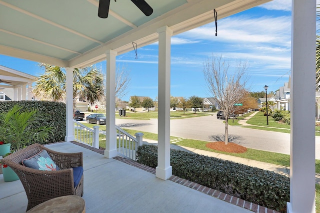 view of patio / terrace with a residential view, a porch, and a ceiling fan