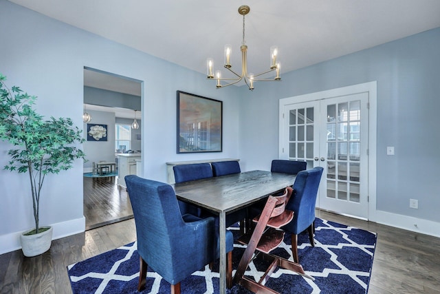 dining space with a chandelier, french doors, baseboards, and wood finished floors