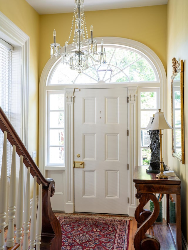 foyer entrance featuring a notable chandelier