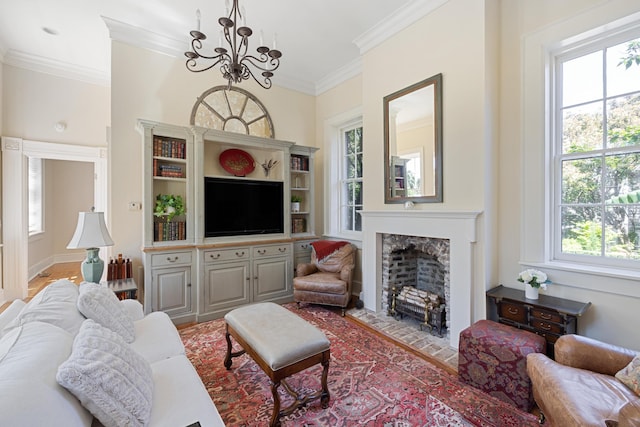 living room featuring a chandelier, a wealth of natural light, a high end fireplace, and ornamental molding