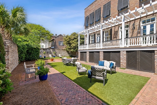 view of yard featuring a patio, an outdoor living space, and a pergola