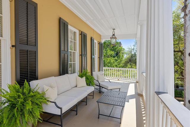 balcony featuring covered porch and outdoor lounge area