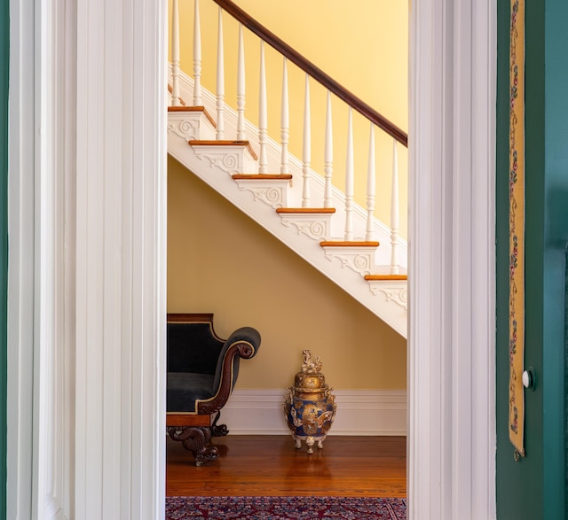 stairs featuring hardwood / wood-style flooring