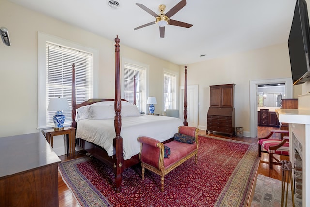 bedroom with ceiling fan and dark wood-type flooring