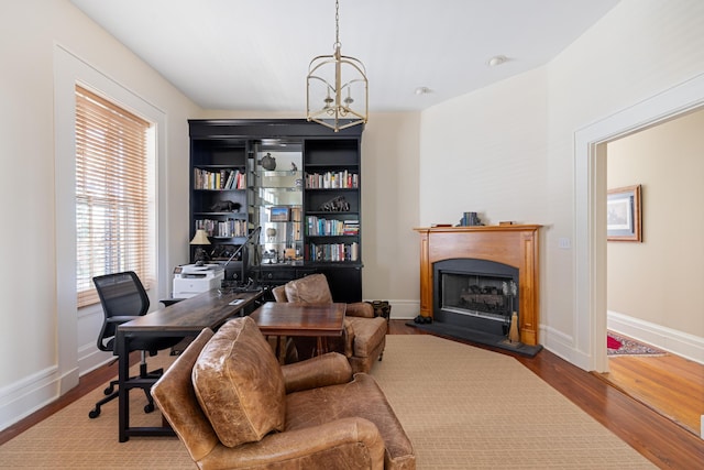 office area featuring hardwood / wood-style floors and an inviting chandelier