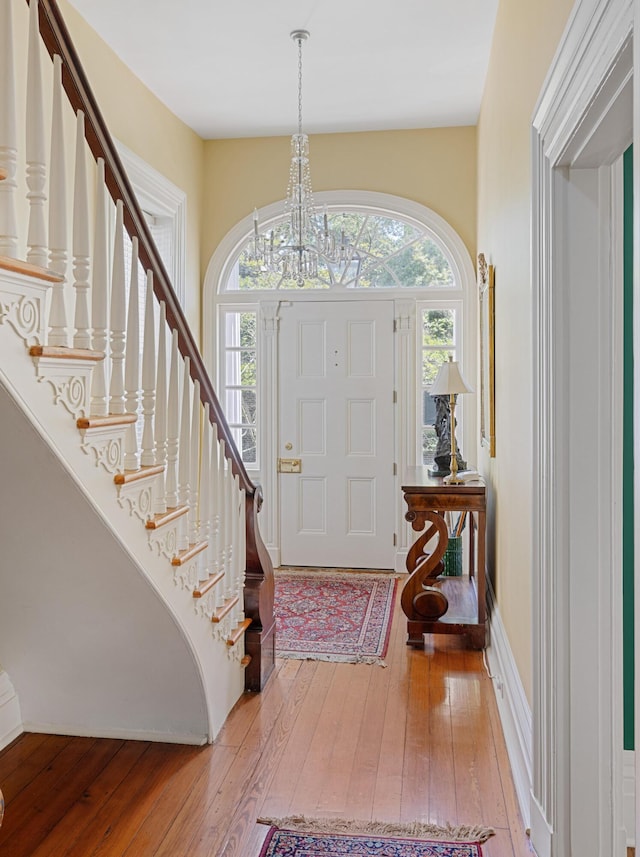 foyer featuring wood-type flooring and a chandelier