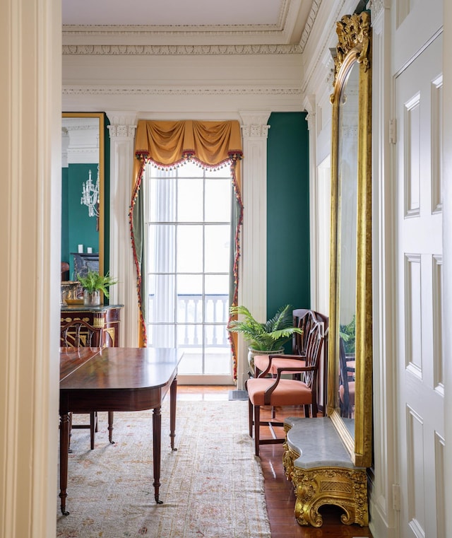 sitting room featuring hardwood / wood-style floors and crown molding