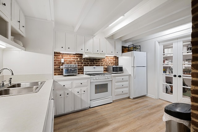 kitchen with white cabinetry, sink, white appliances, and beamed ceiling