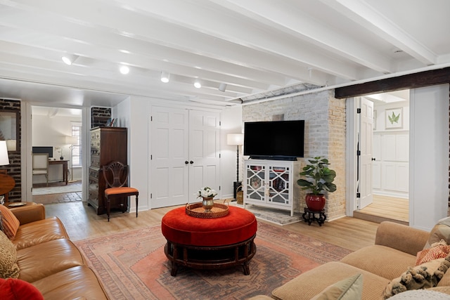 living room featuring light wood-type flooring and beam ceiling