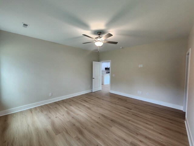 1207 Albert Storm Ave, Moncks Corner, SC 29461 - empty room featuring light wood finished floors, ceiling fan, and baseboards