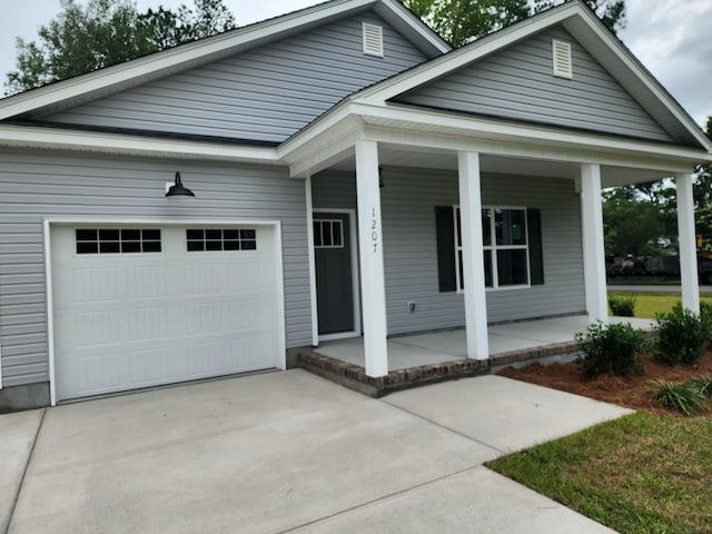 1207 Albert Storm Ave, Moncks Corner, SC 29461 - ranch-style house with covered porch, driveway, and a garage