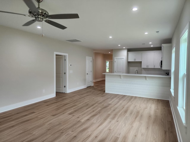 1207 Albert Storm Ave, Moncks Corner, SC 29461 - unfurnished living room with recessed lighting, light wood-style floors, a ceiling fan, a sink, and baseboards