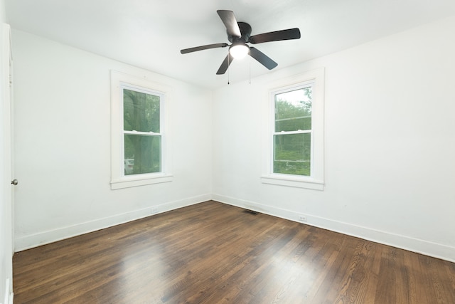 spare room with dark hardwood / wood-style flooring and ceiling fan