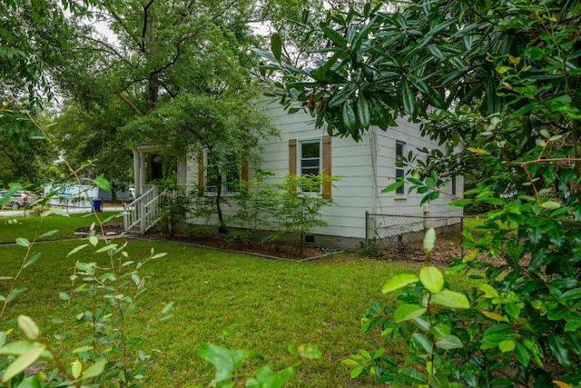 view of side of home featuring a lawn