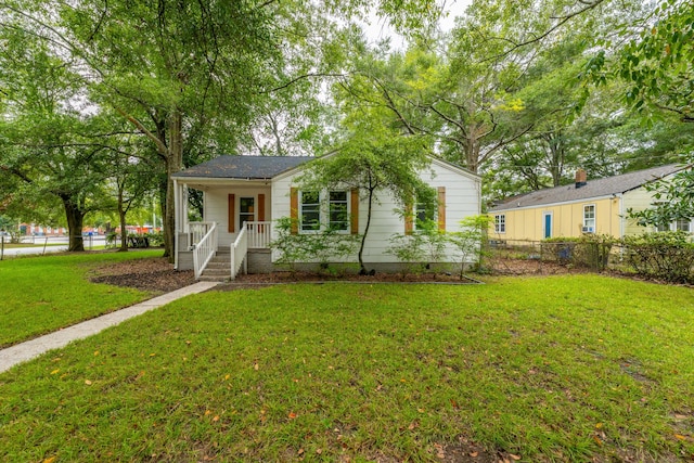 single story home featuring a front lawn and covered porch