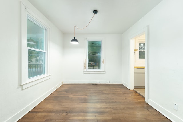 unfurnished dining area with dark hardwood / wood-style floors