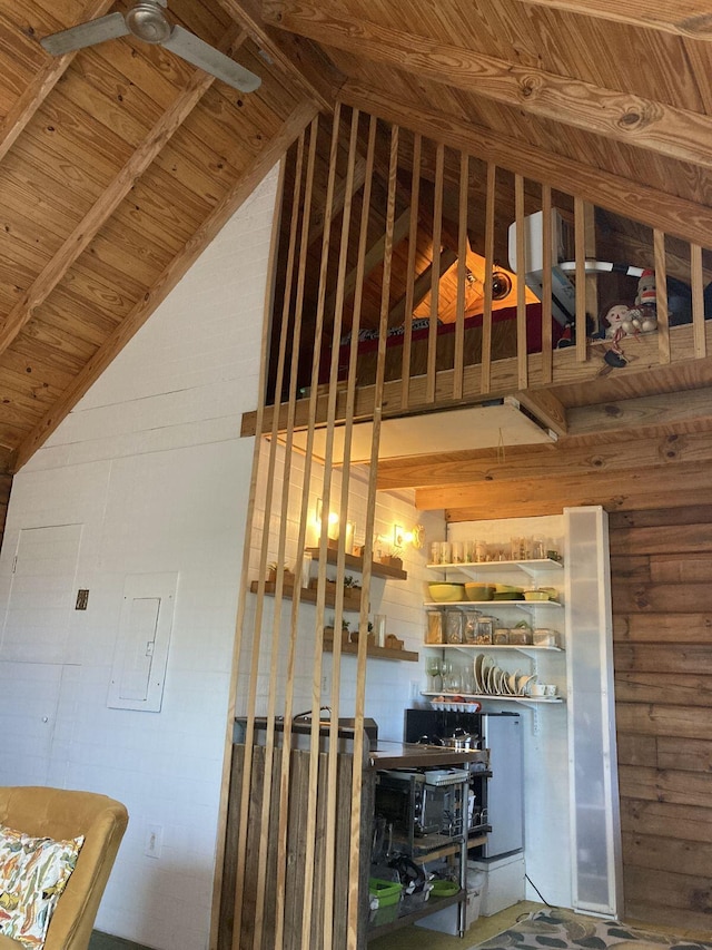 interior space featuring beam ceiling, wooden walls, electric panel, and wooden ceiling