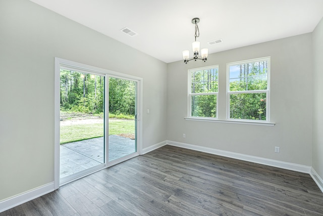 unfurnished room with dark hardwood / wood-style flooring and a chandelier