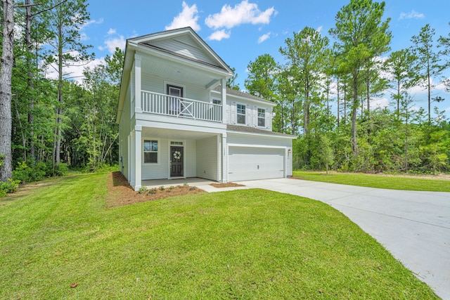 view of front of home with a front yard, a garage, and a porch