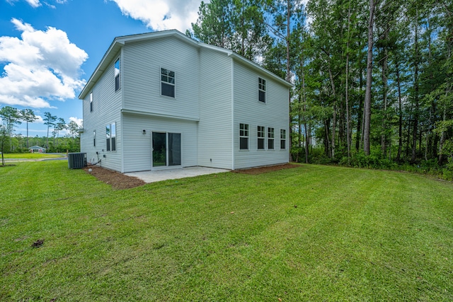 rear view of property featuring central air condition unit, a patio area, and a lawn