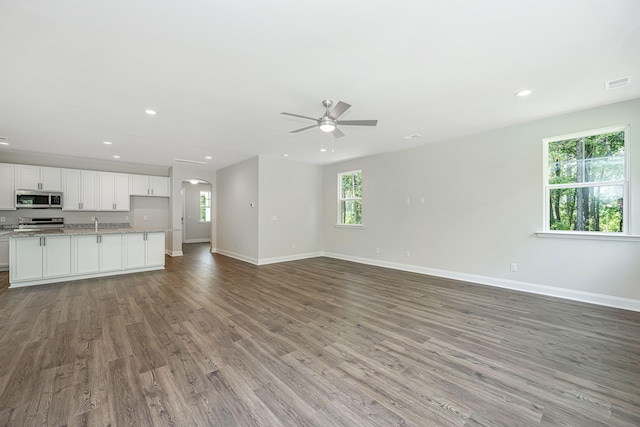 unfurnished living room featuring light hardwood / wood-style floors and ceiling fan