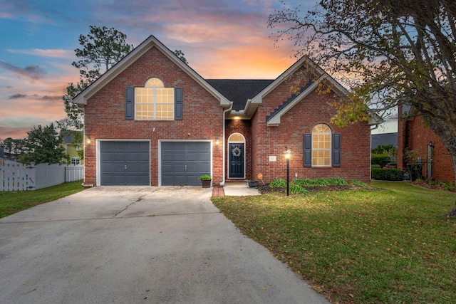 front facade with a yard and a garage