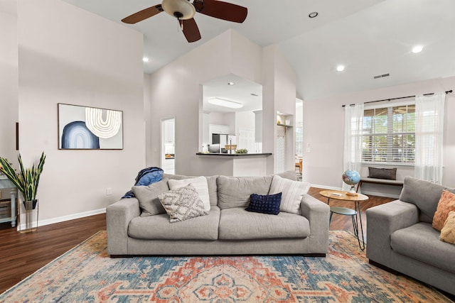 living room featuring hardwood / wood-style flooring, high vaulted ceiling, and ceiling fan