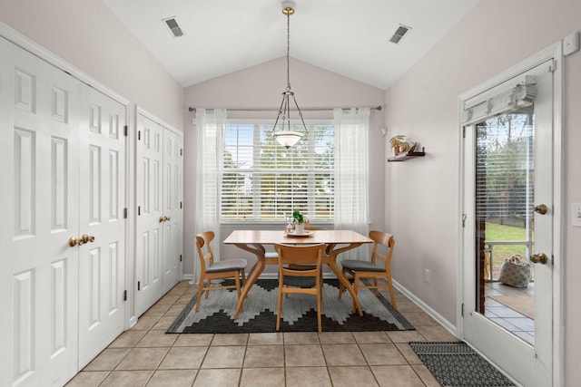 tiled dining area featuring lofted ceiling