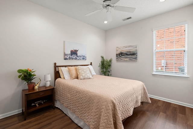 bedroom featuring a textured ceiling, dark hardwood / wood-style flooring, and ceiling fan