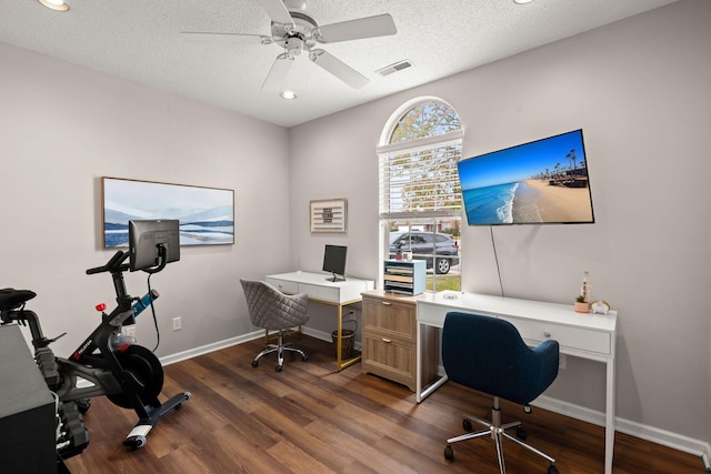 home office featuring a textured ceiling, ceiling fan, and dark wood-type flooring