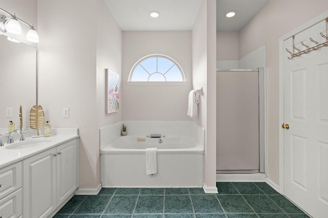 bathroom with vanity and shower with separate bathtub