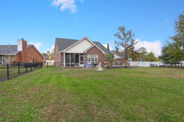 back of property with a lawn and a sunroom