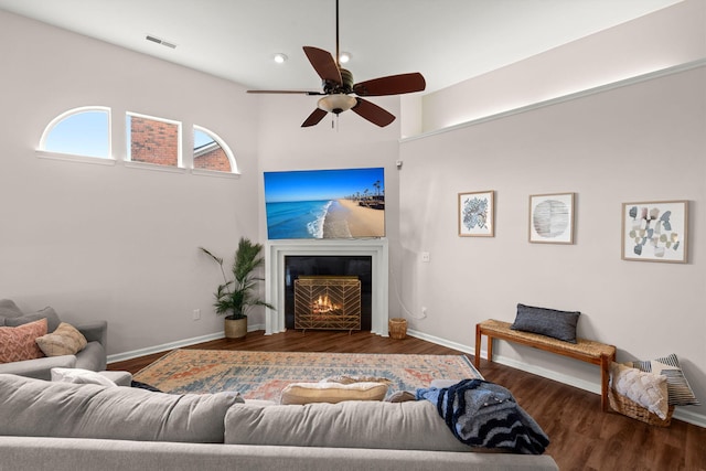 living room featuring dark hardwood / wood-style floors and ceiling fan