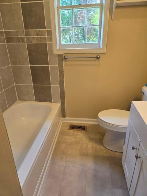 bathroom with vanity, tile patterned flooring, and toilet