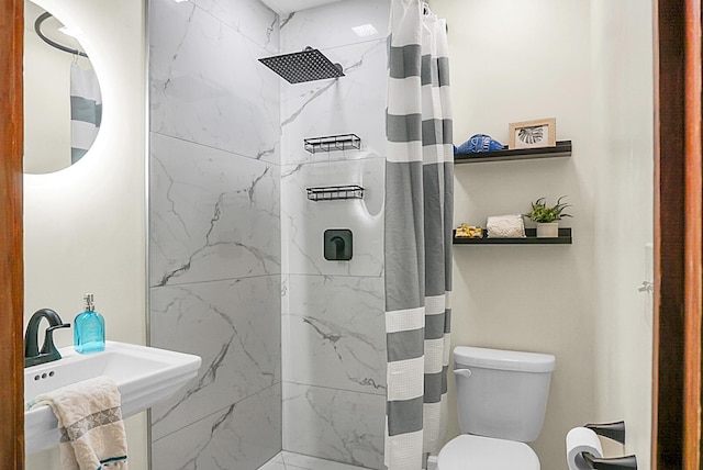 bathroom with curtained shower and toilet