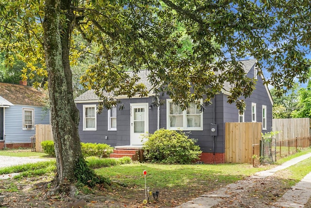 view of front of house with fence and a shingled roof