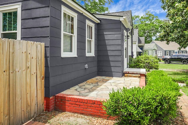 view of home's exterior featuring fence
