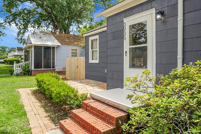 doorway to property with a lawn