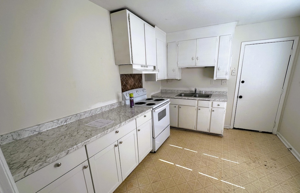 kitchen with white electric range, a sink, light countertops, white cabinets, and under cabinet range hood