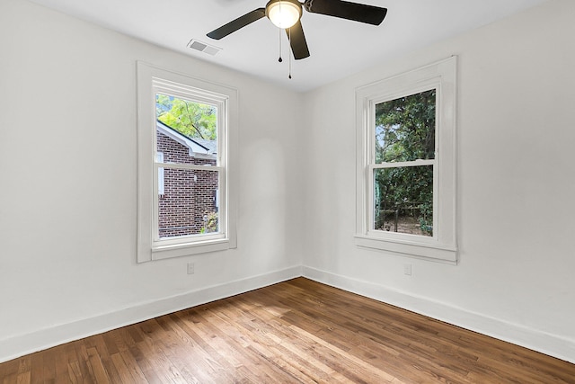 unfurnished room with hardwood / wood-style flooring and ceiling fan